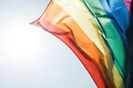image of the LGBTQ+ pride flag waving in sky