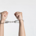 Picture of hands in handcuffs.